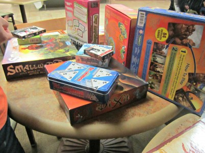 Board games piled on a table at the interest meeting. Photo Credit: VICTORIA ORTIZ 