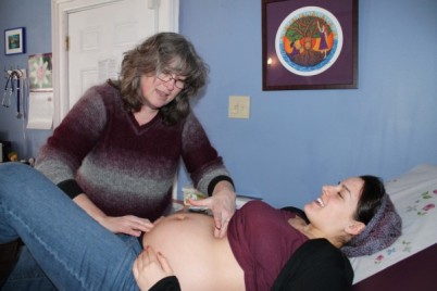 McDermott measuring Perotto's pregnant belly. Photo Credit: Lauren Halligan