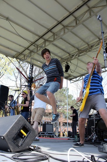 Singer Alex Koste takes a jump on stage (Photo Courtesy Kelly Pfeister)